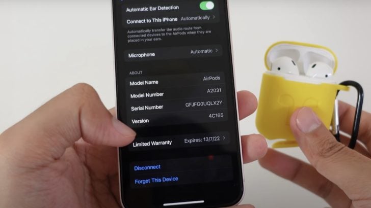 Photo of person checking airpods firmware version on iphone