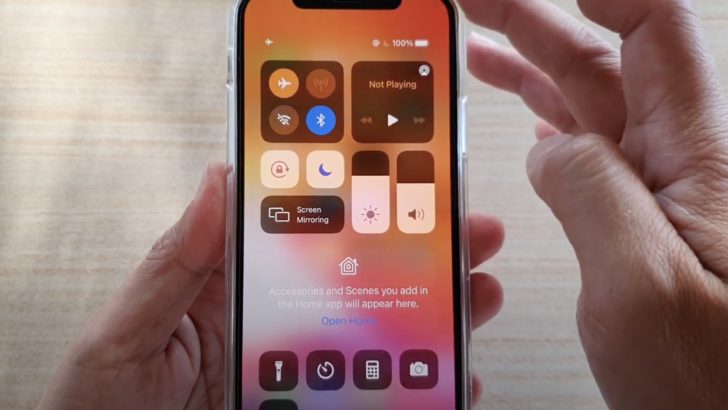 Photo of person holding iphone on airplane mode with bluetooth on