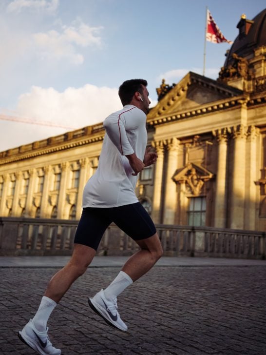 Photo of person running wearing airpods