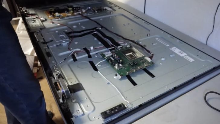 Photo of person dismantling a sony tv with broken screen