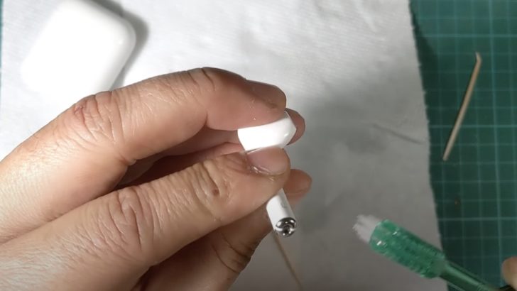 Photo of bottom of airpods cleaned using toothbrush