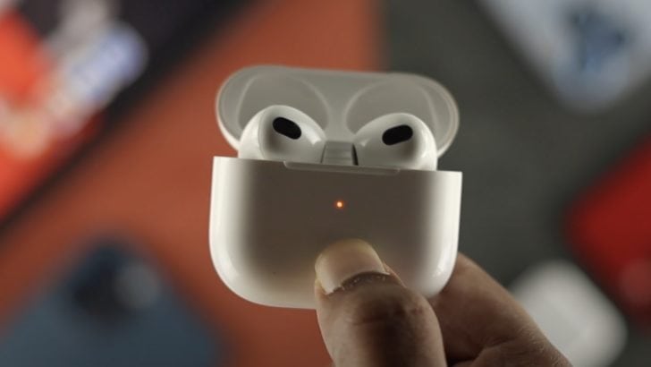 Photo of person resetting airpods