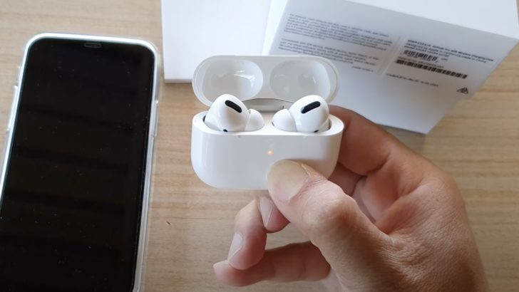 Photo of person resetting airpods