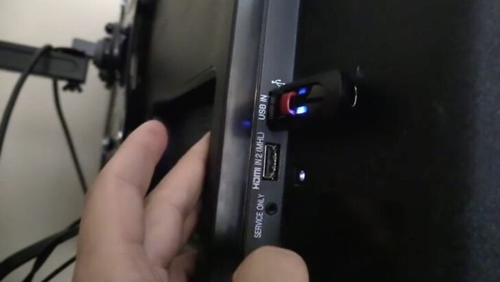 Photo of person updating lg tv firmware via usb