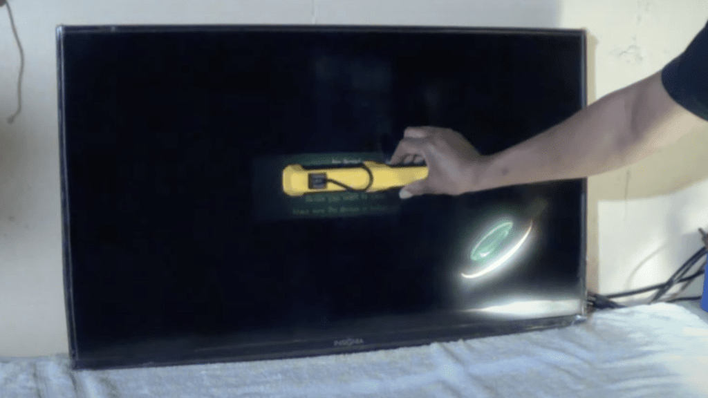 Photo of a person doing a flashlight test to check for a broken backlight