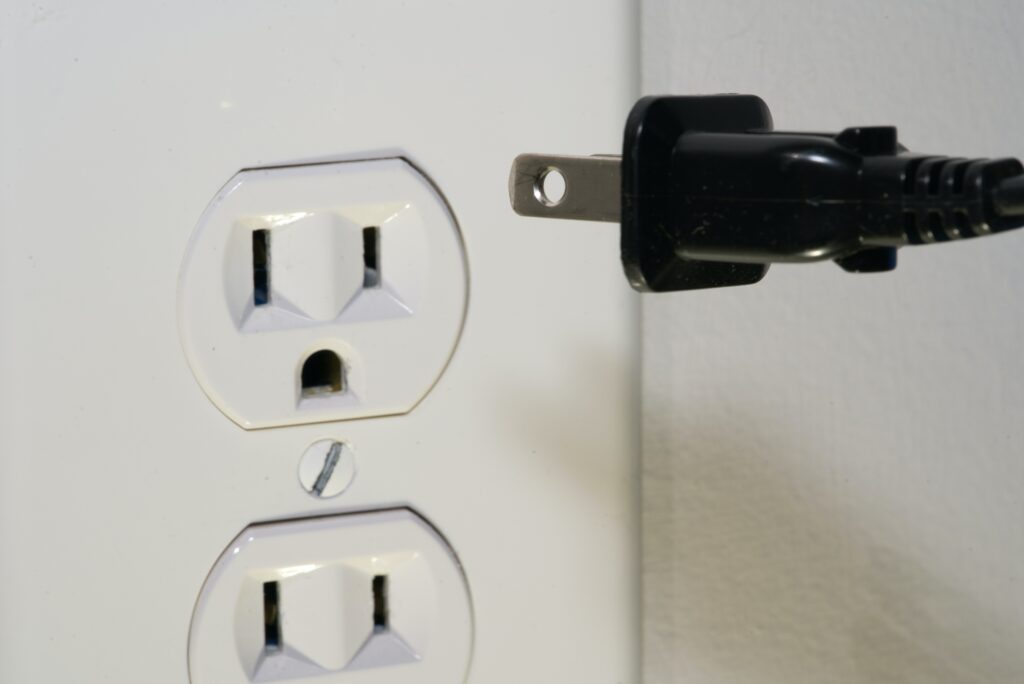 Photo of a power cord and a wall outlet
