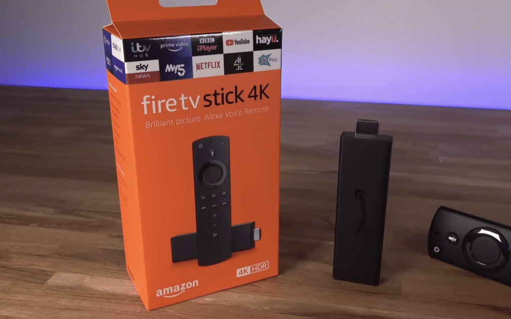 Photo of a 4K Amazon Firestick box, the streaming device, and the remote