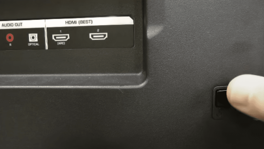 Photo of a person power cycling a Vizio TV