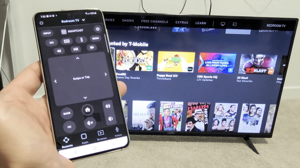 Photo of a person using the old Vizio TV SmartCast app as the remote