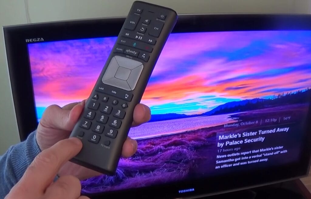man holding an Xfinity remote control