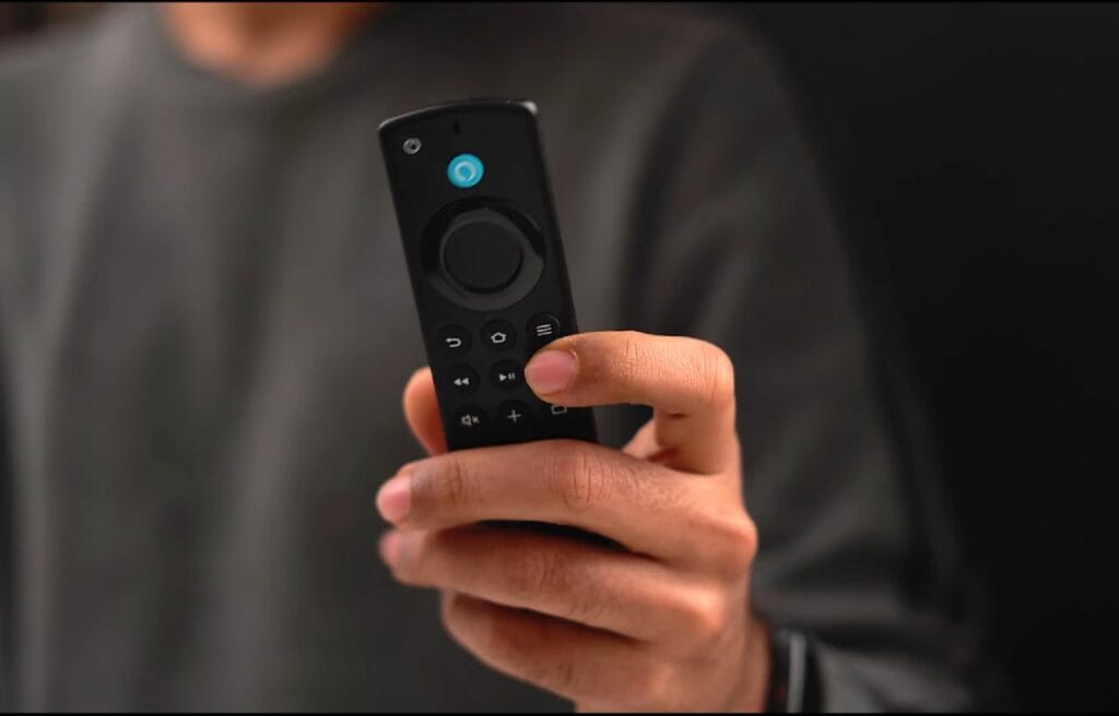 a man holding a Firestick remote