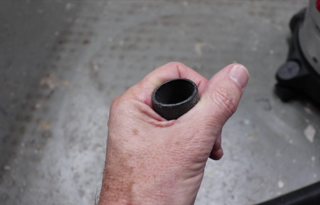 hand holding end of a vacuum hose