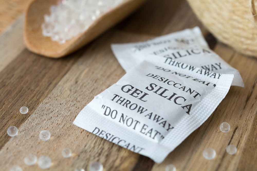 pack of silica gels on a wooden table 