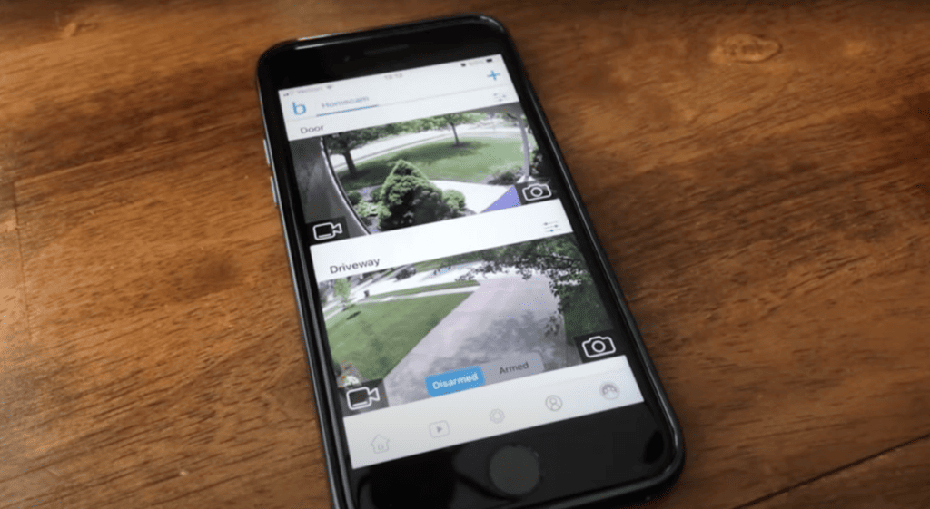 Blink app on an iPhone laying on a wooded table