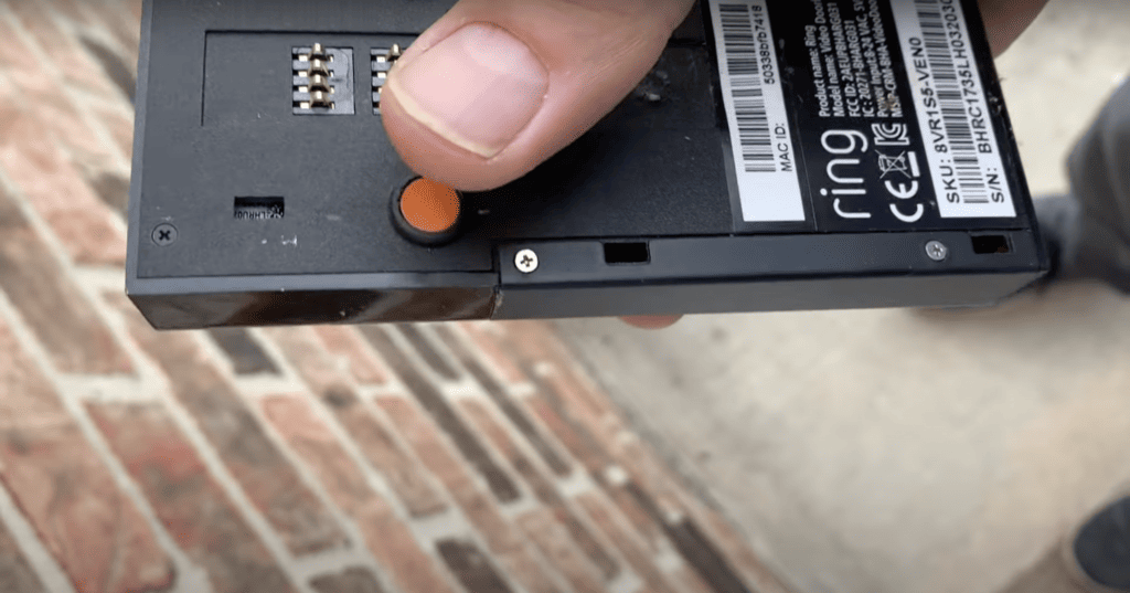 Pressing the orange button of the Ring doorbell