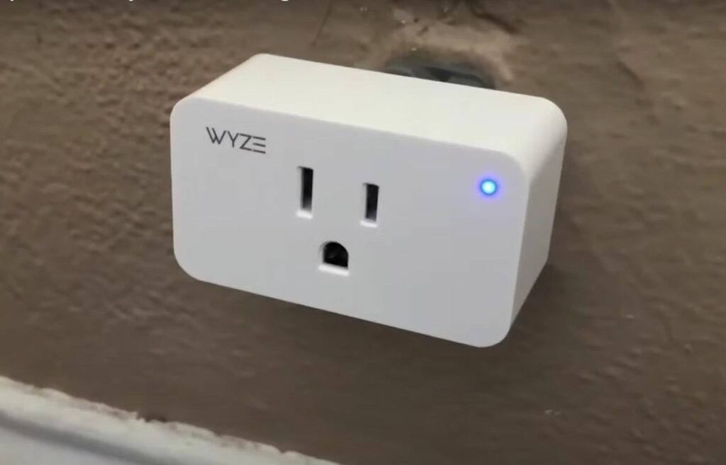 A Wyze Plug plugged in a socket