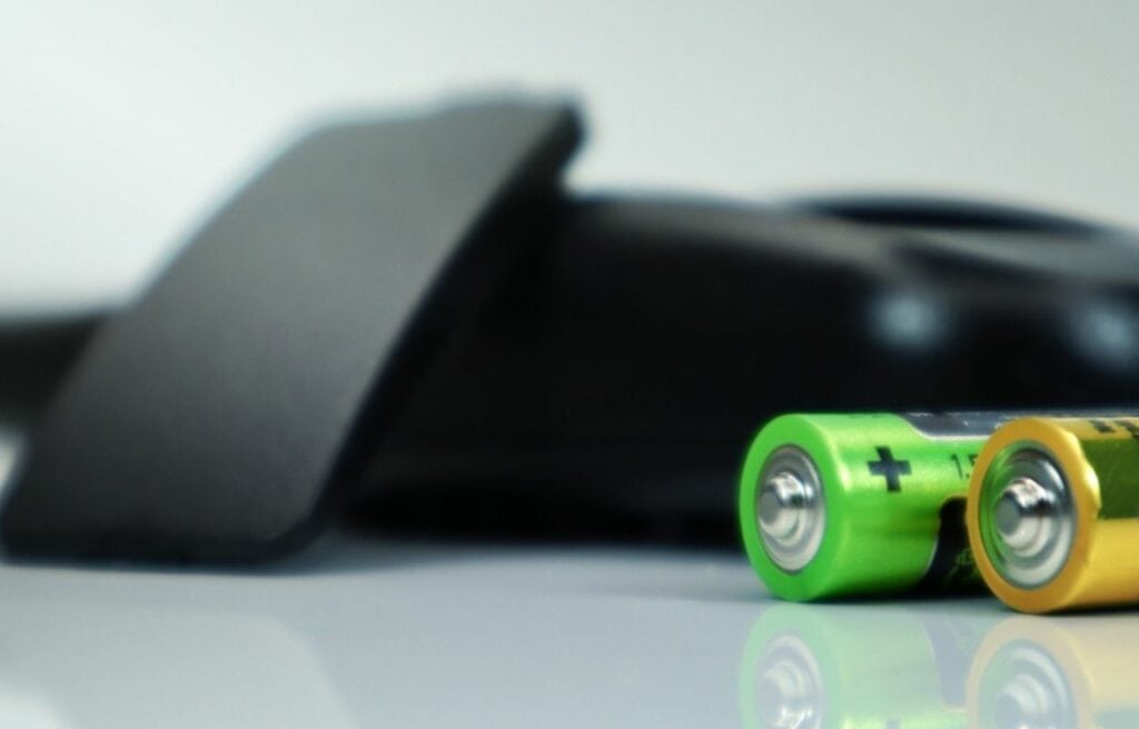 black TV remote and AA batteries 
