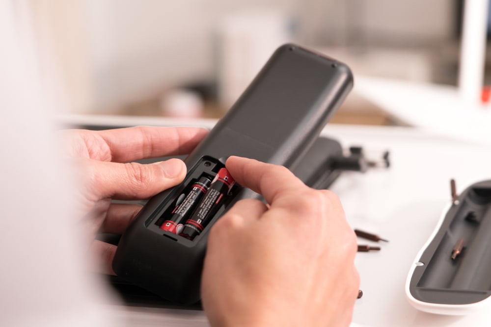 changing the batteries of a TV remote control