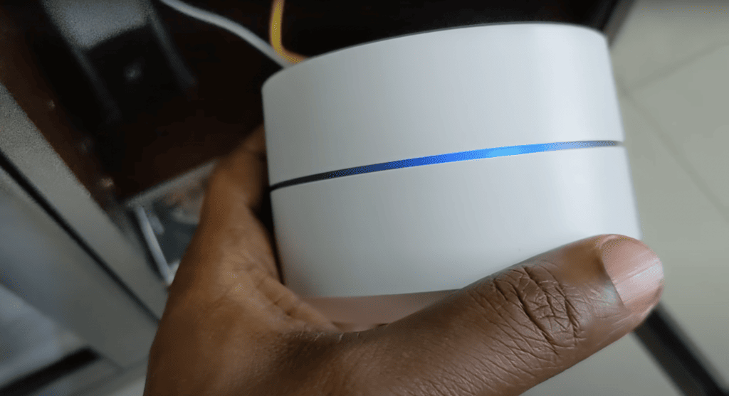 Google WiFi held by a man