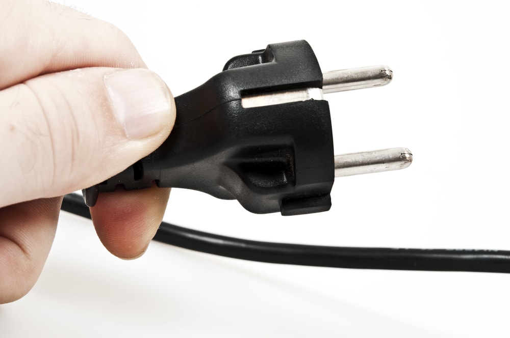 Unplugging the Samsung TV's outlet in white background