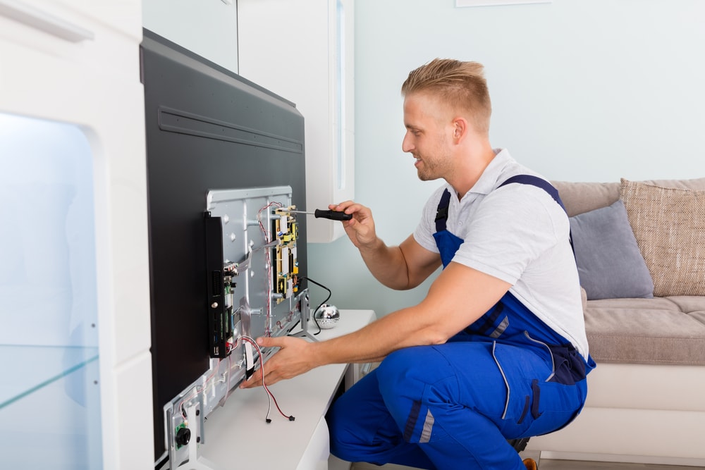Man repairing the TV