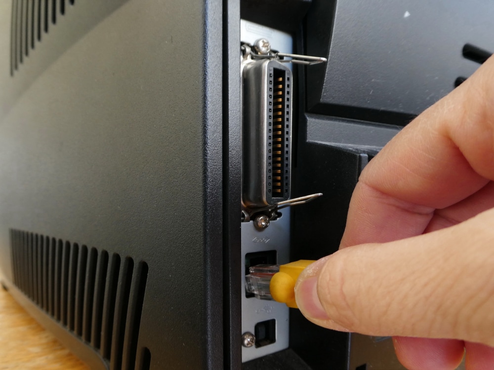plugging an Ethernet cable on a printer
