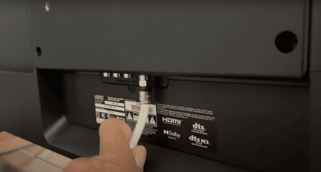 Checking the cable at the back of a Vizio TV